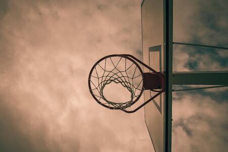 basketball hoop in a community park waiting for the storm to start with a dramatic sky in Spainの写真素材