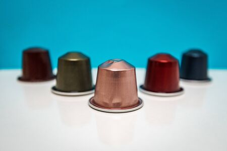 five colorful coffee capsules arranged with a blue backgroundのeditorial素材