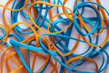 pile of colorful small rubber bands isolated on a white back ground randomly placedの写真素材