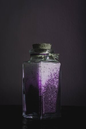 fancy bottle with lavender bath salts for relaxing spa treatments with white backgroundの写真素材