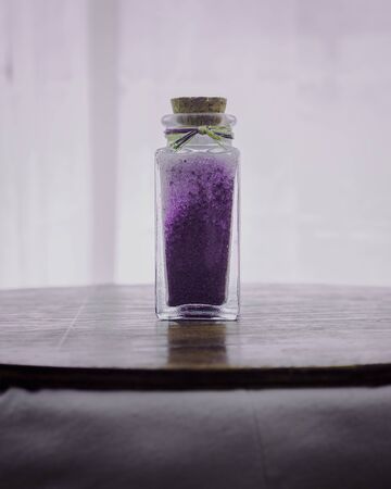 fancy bottle with lavender bath salts for relaxing spa treatments with white backgroundの写真素材