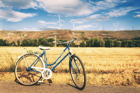 vintage blue bicycle parked in the rural countryside in a summer day of Palencia, Spainの写真素材