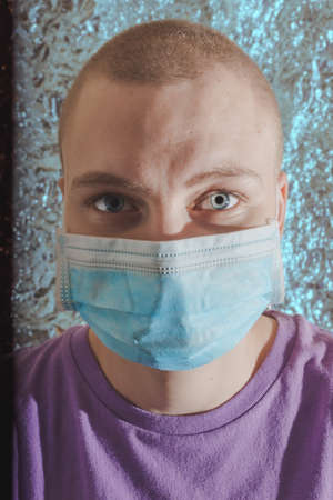 caucasian woman with breast cancer wearing disposable face maskの写真素材