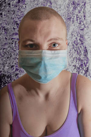 caucasian woman with breast cancer wearing disposable face maskの写真素材