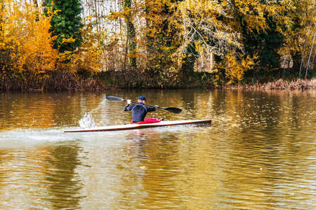 young athletic man training on his kayak canoe in autumn. Palencia, Spainの写真素材