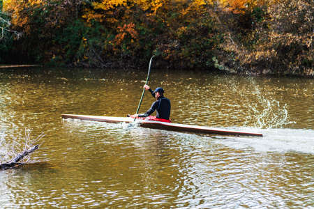 young athletic man training on his kayak canoe in autumn. Palencia, Spainの写真素材