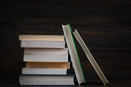 Education concept. Stack of books close up  with rustic wooden background.