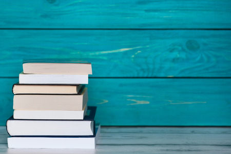books with wooden blue background. Free copy space for text. Back to school. Education backgroundの写真素材