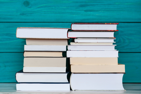 Stacks of books on wooden turquoise background. Education conceptの写真素材