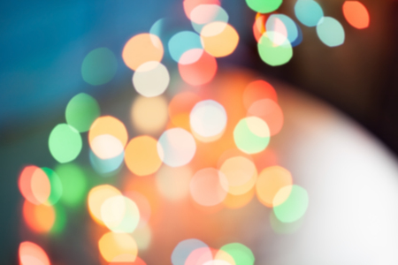 Abstract blurred background. Colorful shimmering Christmas lights bokeh of electric garlandsの写真素材