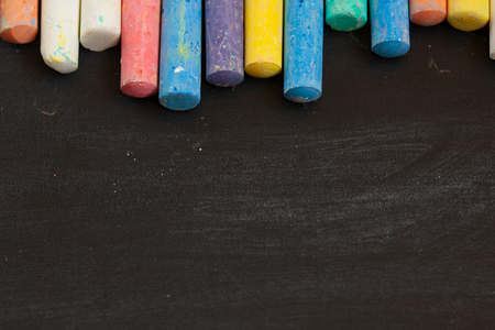 closeup of blackboard with pieces of coloured crayons. Free space for your text. Selective focusの写真素材
