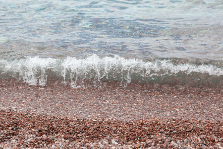 Stone beach of Budva riviera with waves and splashesの写真素材