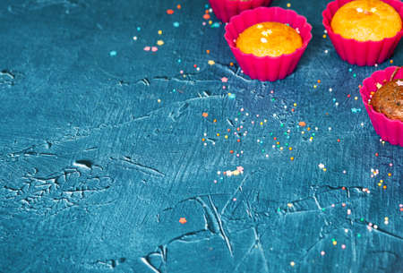 Delicious chocolate and vanilla cupcakes with sweet topping on textured concrete table, top view. Sweet pastriesの写真素材