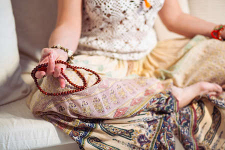 Calm woman meditating. The girl is dressed in ethnic clothes. natural materials. Zen conception. Health mental conceptionの写真素材