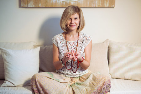 Calm woman meditating. The girl is dressed in ethnic clothes. natural materials. Zen conception. Health mental conceptionの写真素材