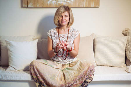 Calm woman meditating. The girl is dressed in ethnic clothes. natural materials. Zen conception. Health mental conceptionの写真素材