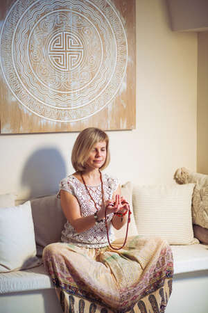 Calm woman meditating. The girl is dressed in ethnic clothes. natural materials. Zen conception. Health mental conceptionの写真素材