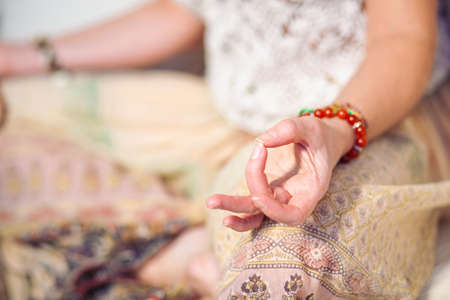 Calm woman meditating. The girl is dressed in ethnic clothes. natural materials. Zen conception. Health mental conceptionの写真素材