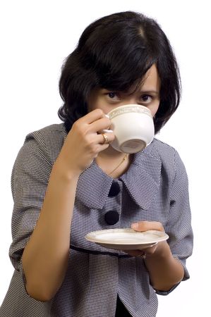 Beautiful Asian Business Woman drink a cup of coffee and sitting at the tableの写真素材