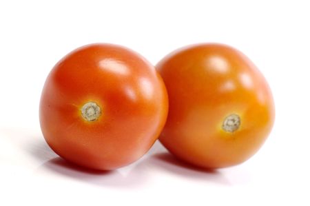 Two tomatoes on white background. Look tasty and freshの写真素材