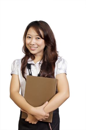 Beautiful college student holding book in her hand. She looks happy and intelligentの写真素材