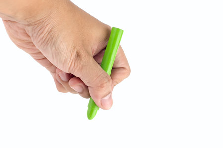 Hand holds green crayon. Ready to drawの写真素材