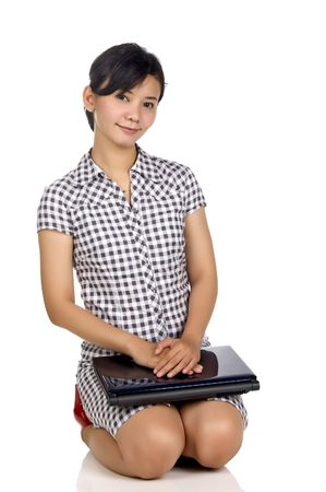 Pretty woman looking at her laptop isolated on white backgroundの写真素材