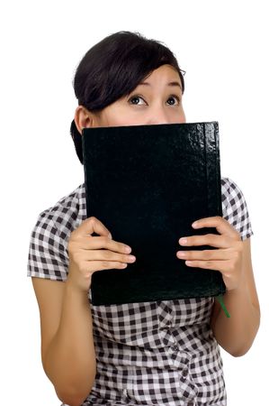 Woman holding book on the face isolated on white backgroundの写真素材
