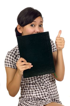Young woman holding books and showing OK. Looking at camera and smiling. Isolated on white backgroundの写真素材