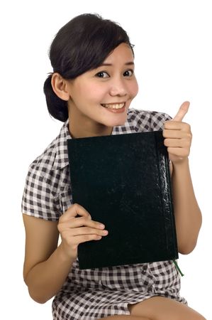 Young woman holding books and showing OK. Looking at camera and smiling. Isolated on white backgroundの写真素材