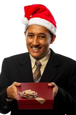 Business man wearing santa's hat is giving a gift isolated on white backgroundの写真素材