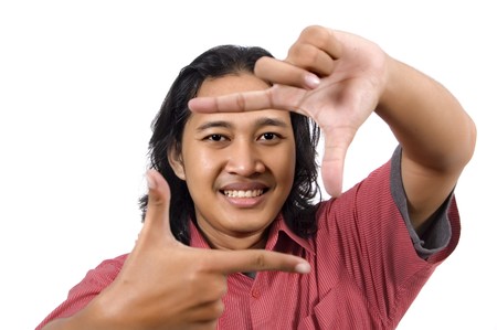 Handsome long hair man framing his face isolated on white backgroundの写真素材