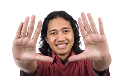Handsome long hair man framing his face isolated on white backgroundの写真素材