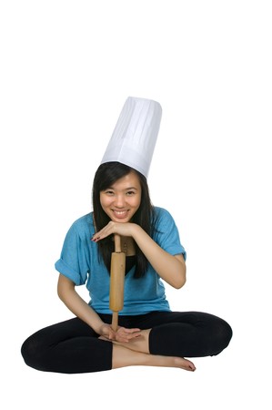 Pretty chinese woman chef wearing chef hat isolated over white backgroundの写真素材
