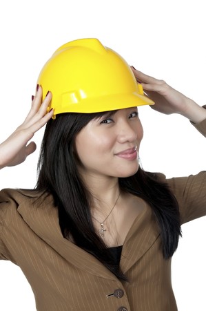 Female Engineer wearing yellow helmet isolated over white backgroundの写真素材