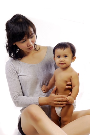 Happy mother with cute baby girl shot in the studioの写真素材