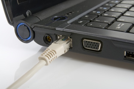 An internet Cable Plugged into an internet port on a laptopの写真素材