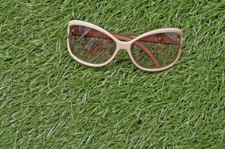 Glasses on green grass on the outdoorの写真素材