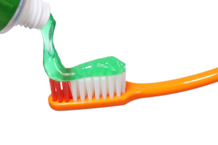 Orange colored toothbrush isolated on white background