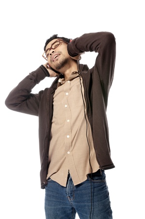 Handsome young man listening to music using headphoneの写真素材