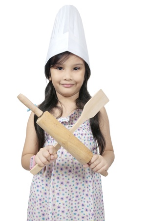Mix race asian caucasian girl hold cooking utensil isolated over white backgroundの写真素材