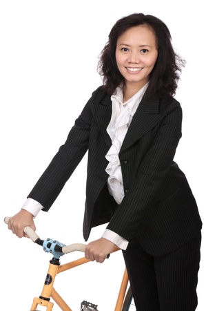 Asian business woman using bike to go workの写真素材