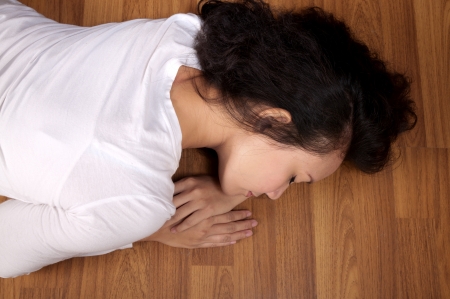 Asian woman tired and sleeping on the wooden floor の写真素材