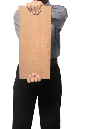 Business man wearing shirt and tie holding wooden board. You can put your message on the boardの写真素材