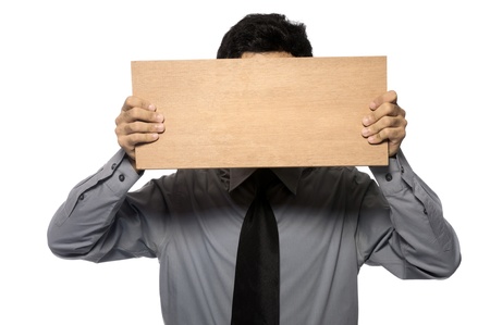 Business man wearing shirt and tie holding wooden board. You can put your message on the boardの写真素材