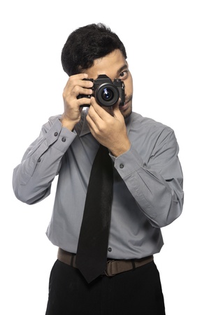 Photographer wearing shirt and tie take photo isolated over white backgroundの写真素材