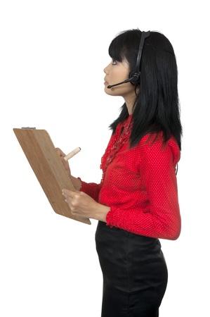 Woman looking up, write on clipboard, wearing headphone isolated over white backgroundの写真素材