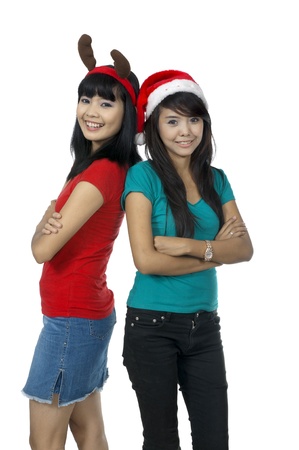 Two girls celebrate christmas isolated over white backgroundの写真素材