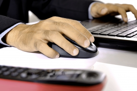 Man typing on laptop isolated over white backgroundの写真素材