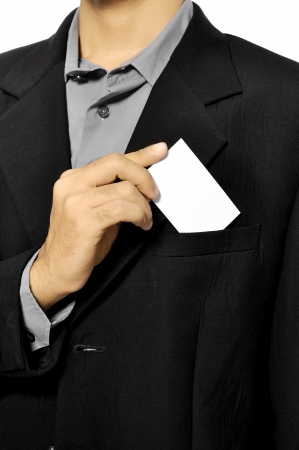 Business man putting a blank business card in his suit pocketの写真素材
